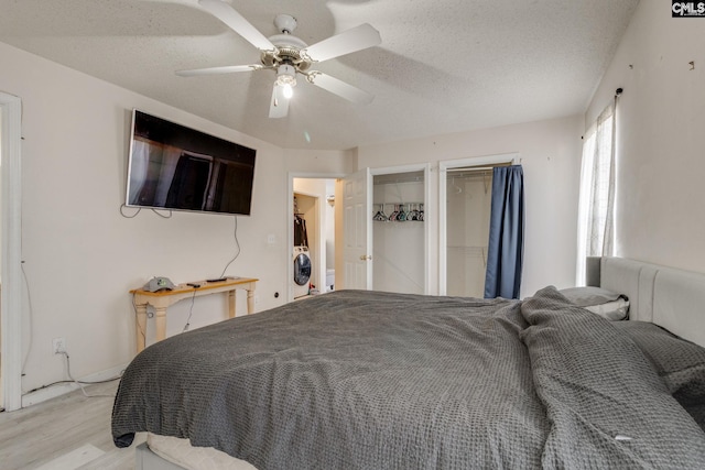 bedroom with a ceiling fan, light wood-type flooring, and a textured ceiling