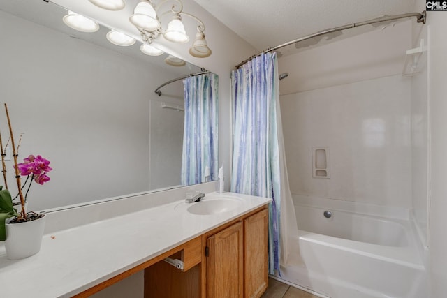 bathroom with vanity, an inviting chandelier, tile patterned flooring, shower / tub combo, and a textured ceiling