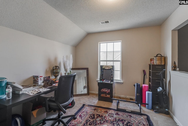 office area with carpet, visible vents, baseboards, lofted ceiling, and a textured ceiling