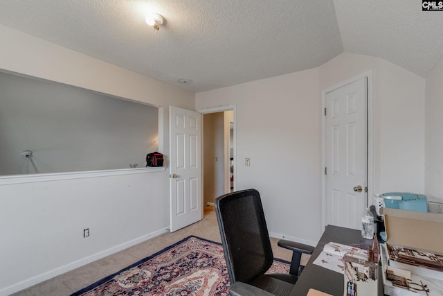 office featuring baseboards, light colored carpet, vaulted ceiling, and a textured ceiling