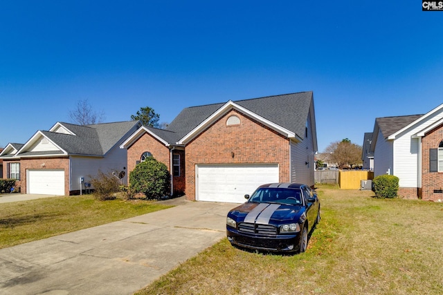 view of front of property featuring brick siding, an attached garage, a front lawn, fence, and driveway