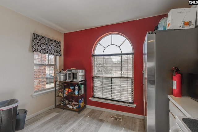 dining area featuring visible vents, baseboards, and wood finished floors