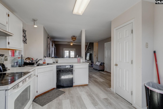 kitchen featuring light wood-style flooring, a peninsula, electric stove, white cabinetry, and a sink