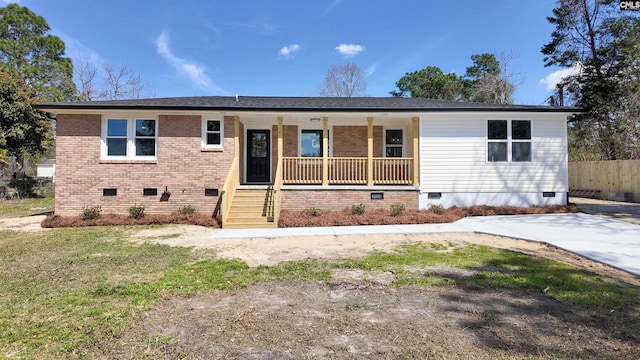 ranch-style house with fence, covered porch, a front yard, crawl space, and brick siding