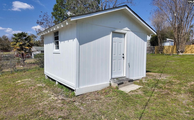 view of outbuilding with an outdoor structure and fence