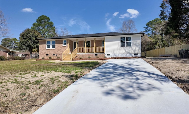 ranch-style home with crawl space, a porch, driveway, and fence