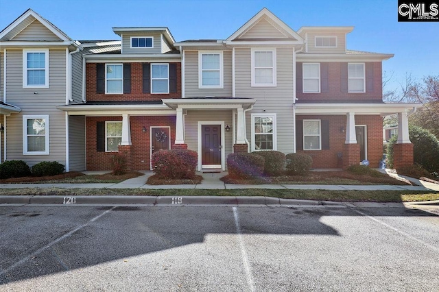 view of property featuring brick siding and uncovered parking