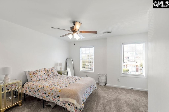 bedroom with visible vents, baseboards, carpet, and ceiling fan