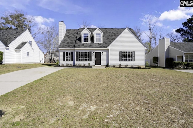 cape cod home with a front yard, driveway, roof with shingles, and a chimney