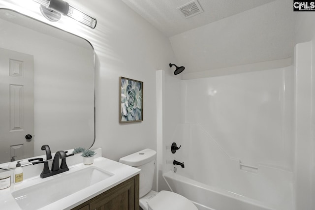 full bath featuring visible vents, toilet, vanity, shower / bathing tub combination, and a textured ceiling