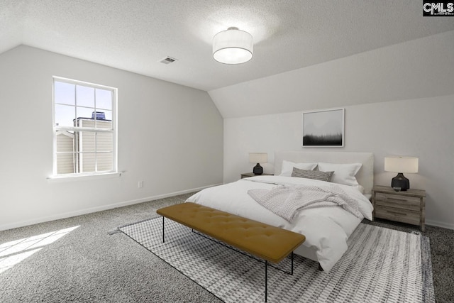 carpeted bedroom featuring lofted ceiling, visible vents, baseboards, and a textured ceiling