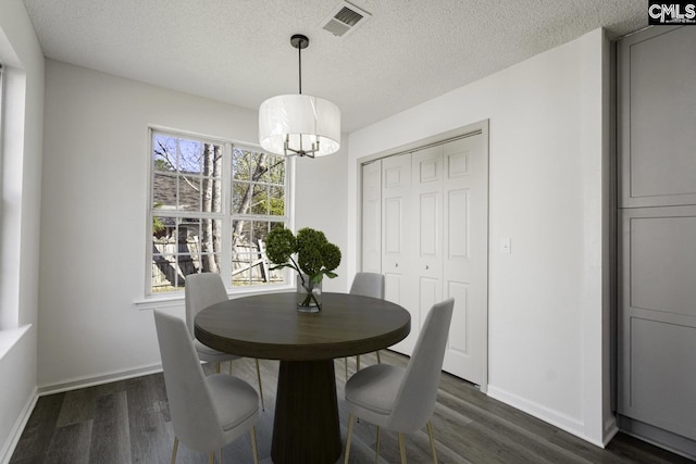 dining area with visible vents, a textured ceiling, baseboards, and dark wood-style flooring