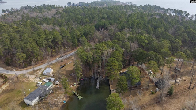 aerial view with a wooded view and a water view