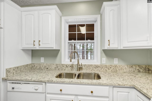 kitchen featuring dishwasher, white cabinetry, and a sink