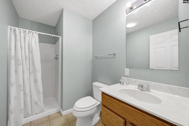 full bath with vanity, toilet, a stall shower, and a textured ceiling