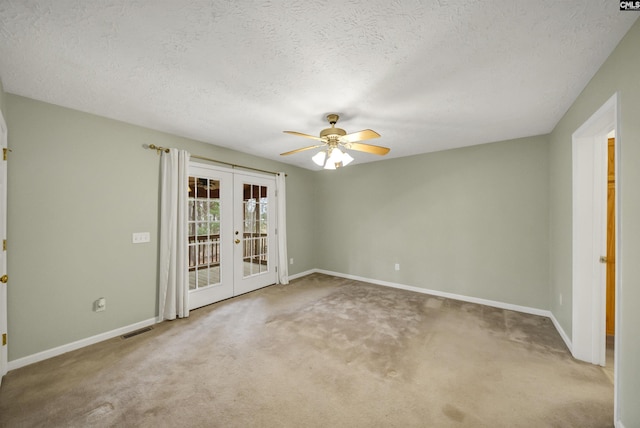 empty room featuring visible vents, a ceiling fan, french doors, carpet, and baseboards