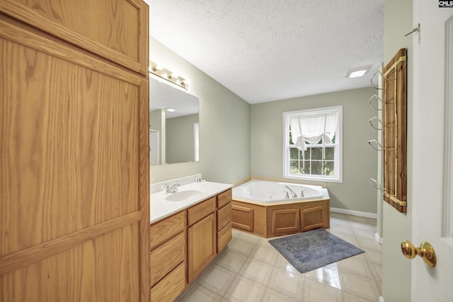 full bathroom featuring vanity, tile patterned floors, a bath, and a textured ceiling