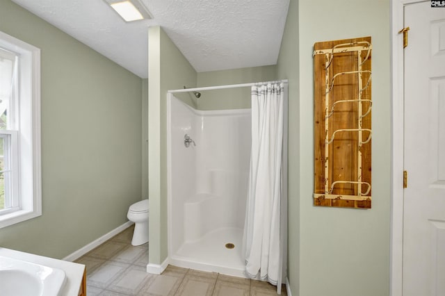 bathroom with baseboards, a textured ceiling, curtained shower, tile patterned floors, and toilet