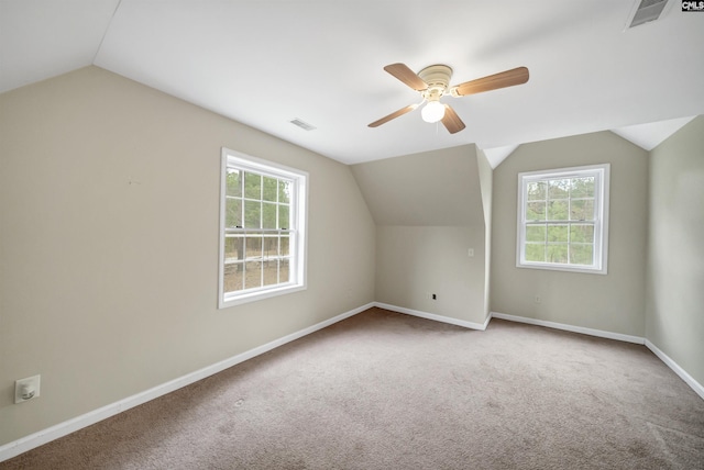 bonus room featuring carpet, visible vents, a ceiling fan, baseboards, and vaulted ceiling