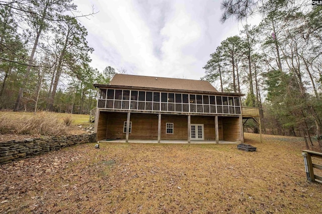 back of property featuring french doors, a patio, and a sunroom