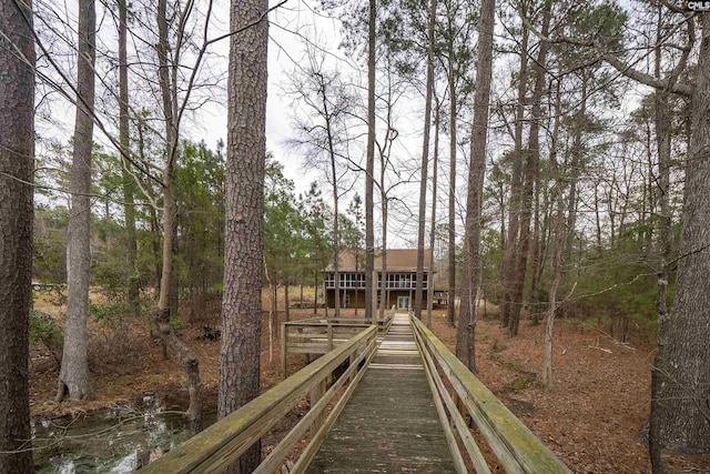 rear view of property with a wooded view