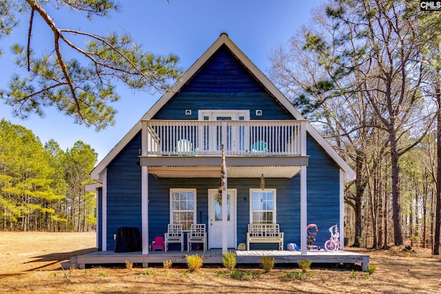 view of front of house with a porch and a balcony