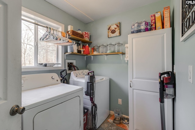 clothes washing area with washer and dryer and laundry area