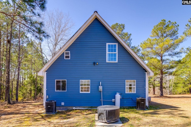 rear view of property with central AC