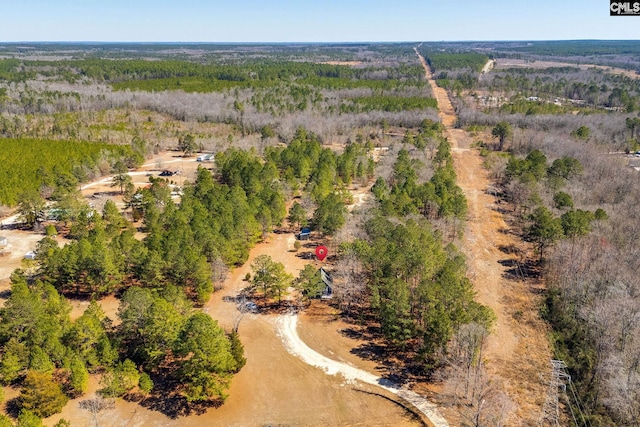 aerial view featuring a wooded view