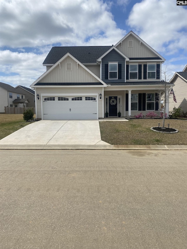 craftsman-style house with concrete driveway, an attached garage, board and batten siding, and a front yard