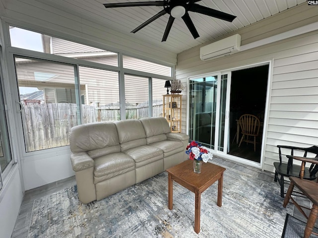 sunroom featuring an AC wall unit and a ceiling fan