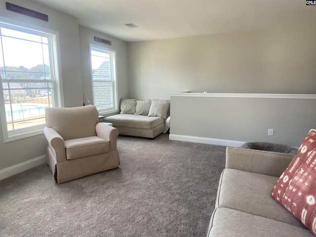 carpeted living room with baseboards and visible vents