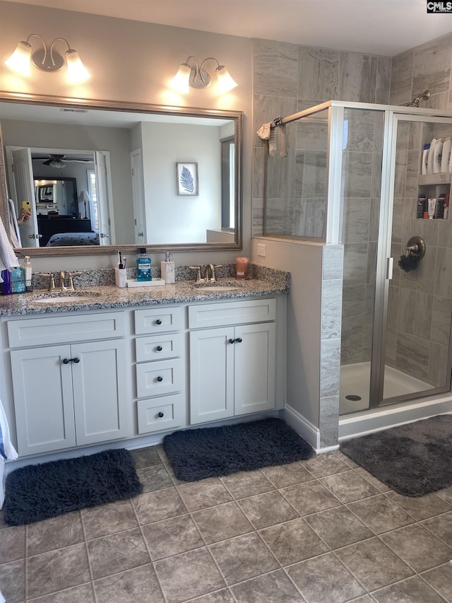 full bath featuring a sink, a shower stall, and ensuite bathroom