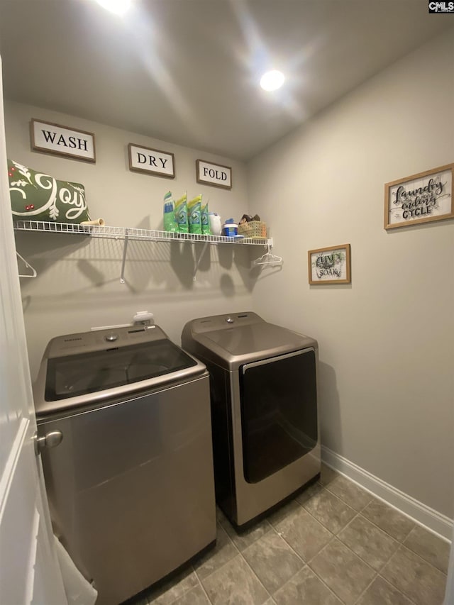 laundry area featuring laundry area, separate washer and dryer, baseboards, and tile patterned floors