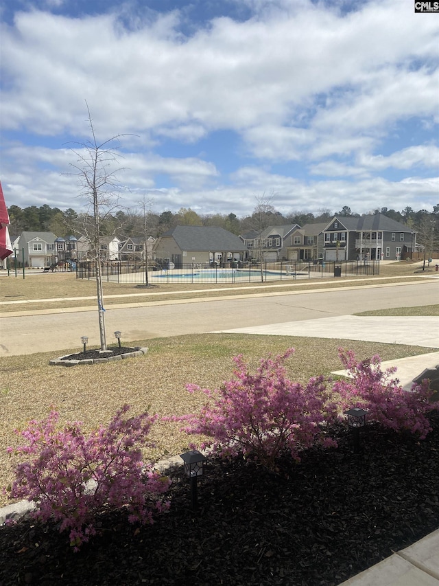 surrounding community featuring a residential view and fence