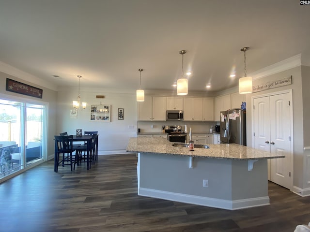 kitchen with a sink, crown molding, white cabinets, and stainless steel appliances