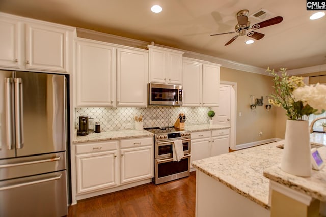 kitchen with visible vents, ornamental molding, decorative backsplash, ceiling fan, and appliances with stainless steel finishes