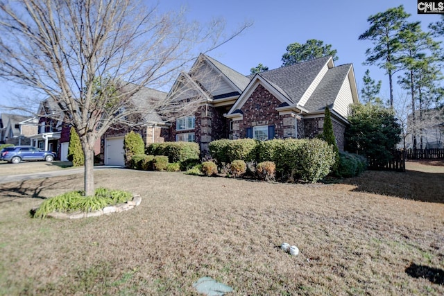 view of front of home featuring a front lawn, an attached garage, and brick siding