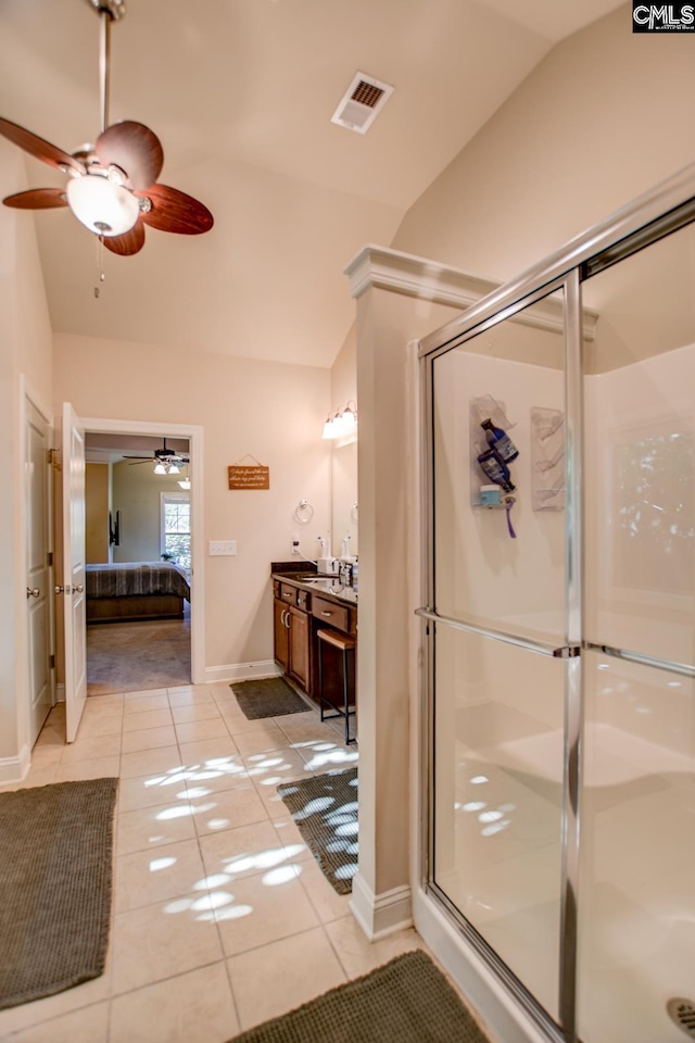 ensuite bathroom with tile patterned floors, visible vents, connected bathroom, ceiling fan, and vaulted ceiling