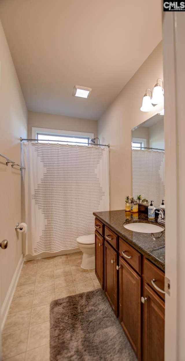 bathroom featuring tile patterned flooring, curtained shower, toilet, and vanity