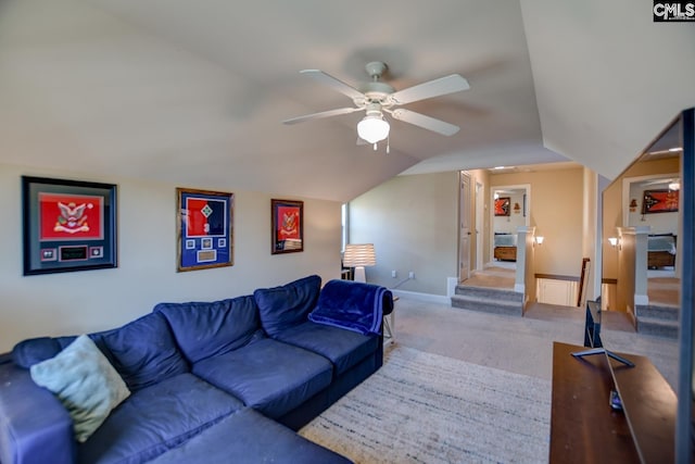 carpeted living area featuring baseboards, a ceiling fan, and vaulted ceiling