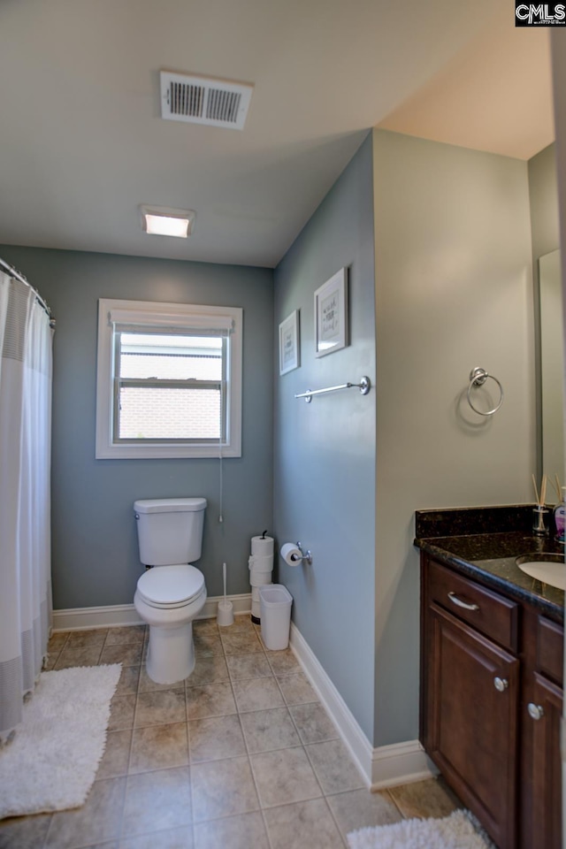 bathroom with visible vents, toilet, vanity, and tile patterned flooring