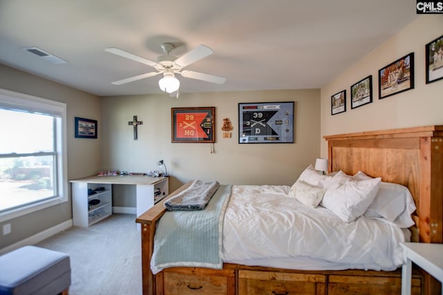 bedroom with baseboards, a ceiling fan, visible vents, and light carpet