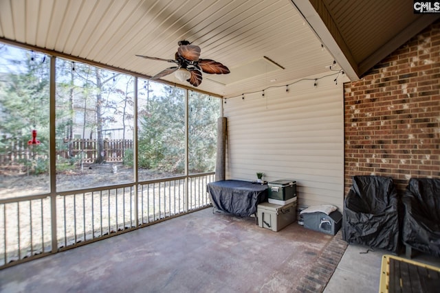 unfurnished sunroom featuring a wealth of natural light and ceiling fan