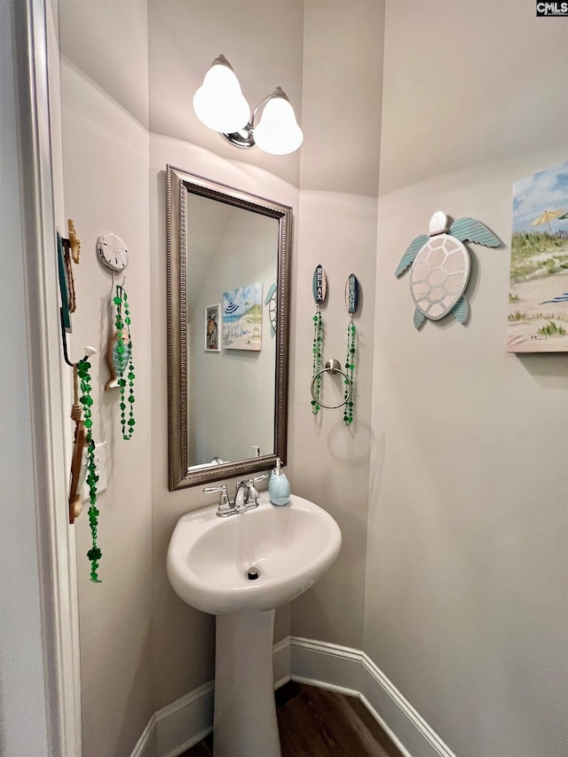 bathroom with baseboards and wood finished floors