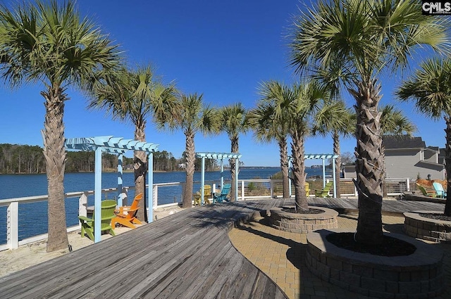 wooden terrace with a pergola and a water view