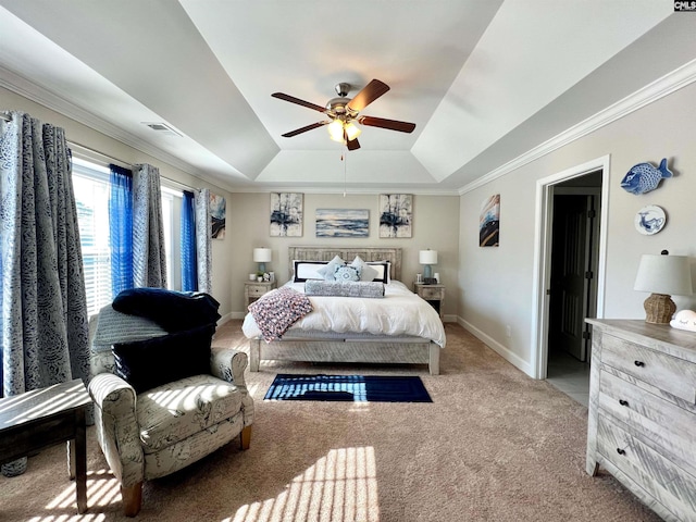 bedroom with visible vents, ornamental molding, baseboards, carpet, and a raised ceiling