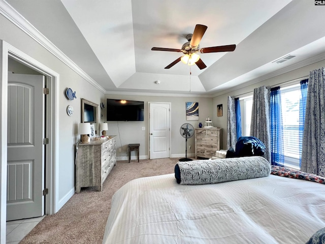 bedroom featuring a tray ceiling, visible vents, baseboards, and crown molding