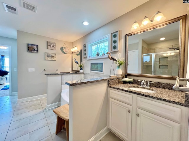 full bath featuring tile patterned flooring, visible vents, a shower stall, and vanity