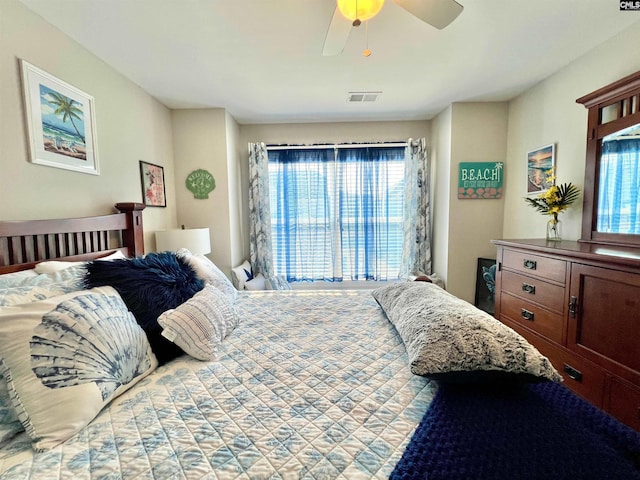 bedroom featuring visible vents, multiple windows, and a ceiling fan